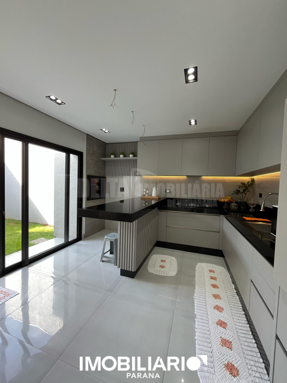 Cozinha americana mobiliada sob medida com detalhe em led e churrasqueira